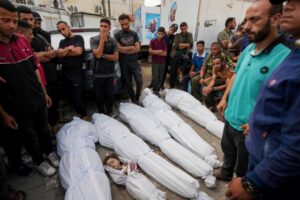 Palestinians mourn their relatives who were killed in an Israeli airstrike in Nuseirat, at the Al Aqsa hospital in Deir al Balah, Gaza Strip, Sunday, May 19, 2024. (AP Photo/Abdel Kareem Hana)