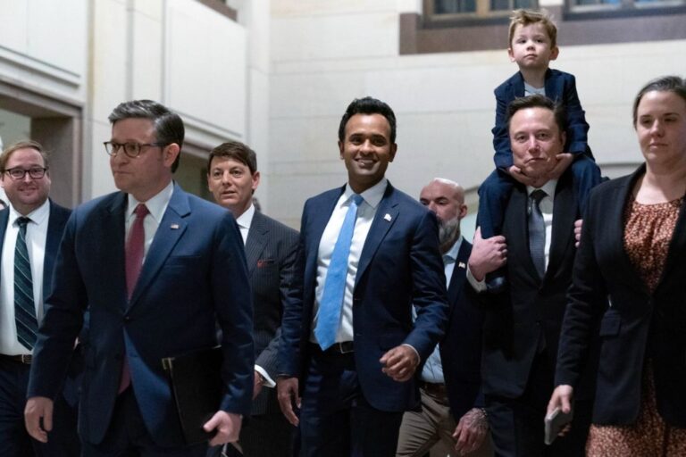 Speaker of the House Mike Johnson, R-La., from left, walks with Vivek Ramaswamy and Elon Musk, who is carrying his son X Æ A-Xii, as they arrive for a roundtable meeting to discuss President-elect Donald Trump's planned Department of Government Efficiency, on Capitol Hill in Washington, Thursday, Dec. 5, 2024. (AP Photo/Jose Luis Magana)