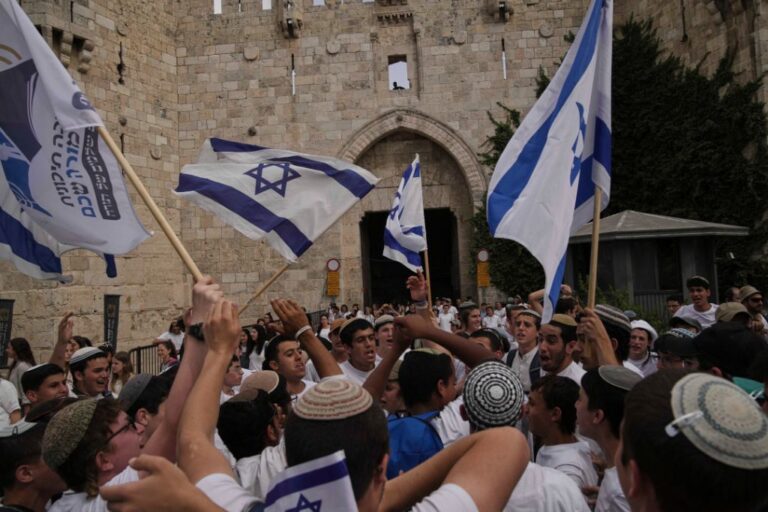 Israelis dance and wave national flags during a march marking Jerusalem Day, an Israeli holiday celebrating the capture of east Jerusalem in the 1967 Mideast war, in Jerusalem's Old City, Monday, May 26, 2025. (AP Photo/Leo Correa)