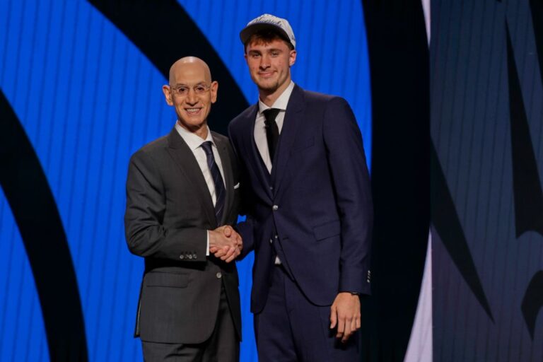 Cooper Flagg, right, poses for a photo with NBA commissioner Adam Silver after being selected first overall by the Dallas Mavericks In the first round of the NBA basketball draft, Wednesday, June 25, 2025, in New York. (AP Photo/Adam Hunger)