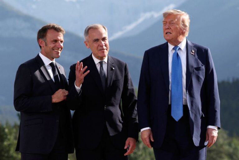 French President Emmanuel Macron, from left, Canada's Prime Minister Mark Carney and U.S. President Donald Trump attend a family photo session during the G7 Summit, in Kananaskis, Alberta, Monday, June 16, 2025. (Suzanne Plunkett/Pool Photo via AP)