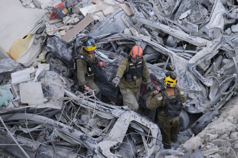 Israeli soldiers dig through rubble to search for survivors in a residential area hit by a missile fired from Iran, near Tel Aviv, Israel, Sunday, June 15, 2025.(AP Photo/Ariel Schalit)