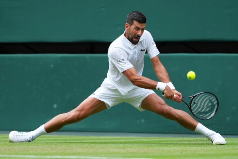 Novak Djokovic of Serbia returns to Miomir Kecmanovic of Serbia during a third round men's singles match at the Wimbledon Tennis Championships in London, Saturday, July 5, 2025. (AP Photo/Kirsty Wigglesworth)