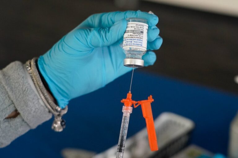 FILE - A nurse loads a syringe with a Moderna COVID-19 booster vaccine at an inoculation station in Jackson, Miss., Nov. 18, 2022. (AP Photo/Rogelio V. Solis, File)