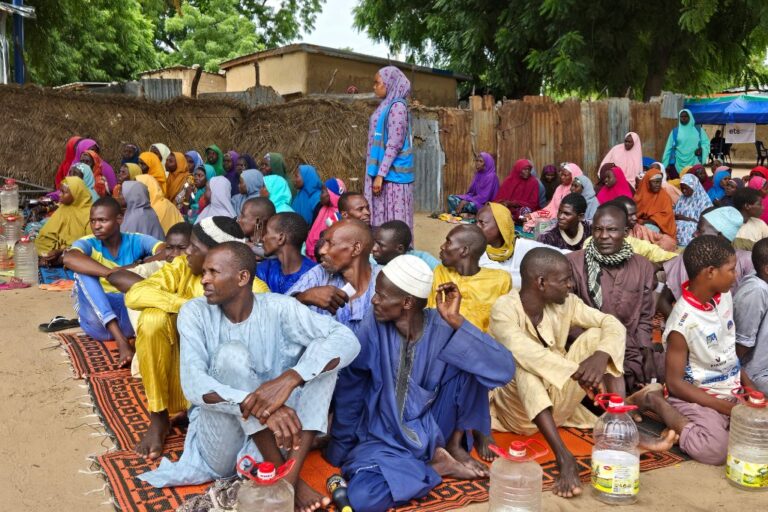 FILE - People wait to receive food donations from the United Nations World Food Program in Damasak, northeastern Nigeria, Oct 6, 2024. (AP Photo/Chinedu Asadu,File)